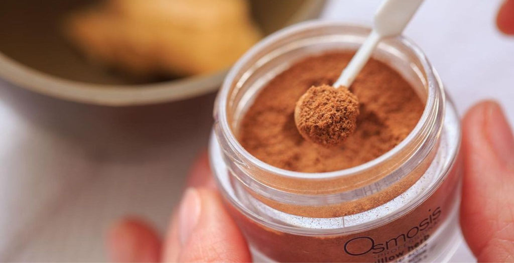 Osmosis beauty product being scooped out of jar 